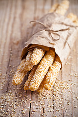 Image showing bread sticks grissini with sesame seeds in craft pack