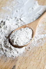 Image showing flour in a wooden spoon 