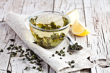 Image showing cup of green tea and lemon 