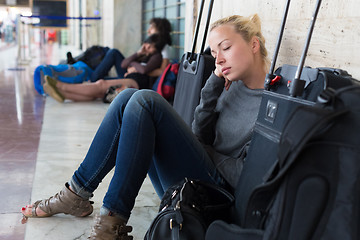 Image showing Tired female traveler waiting for departure.