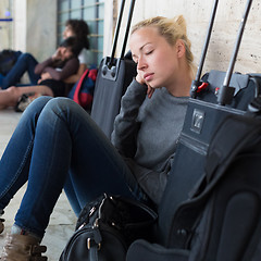 Image showing Tired female traveler waiting for departure.