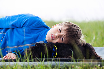 Image showing Young boy with dog