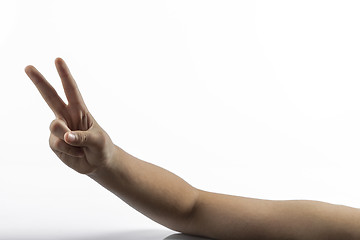 Image showing Young hands making victory sign