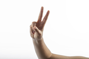 Image showing Young hands making victory sign