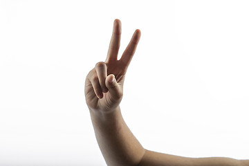 Image showing Young hands making victory sign