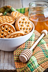 Image showing fresh cookies in a bowl, tablecloth and honey