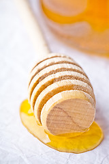 Image showing honey on wooden honey dipper 