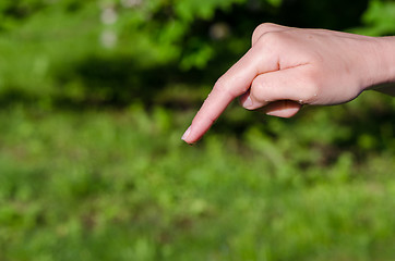 Image showing womans hand with water drop on the end of finger  