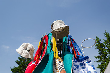 Image showing linen cap bag on fair stand on blue sky background