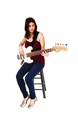 Image showing Sitting woman playing guitar.