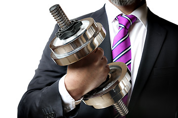 Image showing Businessman holding silver dumbbell