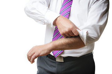 Image showing Business Man rolls up sleeves