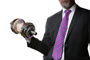 Image showing Businessman holding silver dumbbell