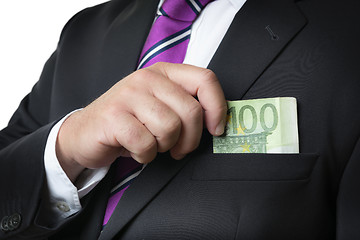 Image showing Businessman putting money in pocket