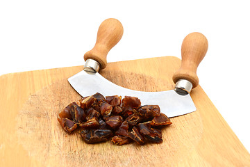 Image showing Chopped dates with a rocking knife 