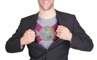 Image showing Businessman opening suit to reveal shirt with state flag