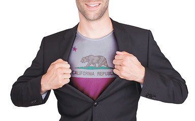 Image showing Businessman opening suit to reveal shirt with state flag