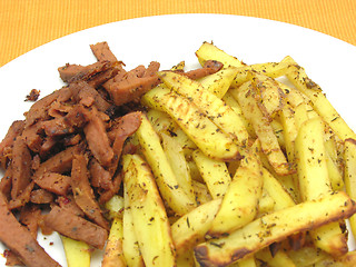 Image showing Soy Geschnetzeltes and french fries on white plate