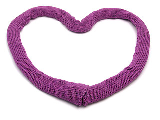 Image showing Deep pink knitting scarf arranged as heart on white