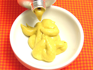 Image showing Mustard  pressed out of a mustard tube in a little bowl