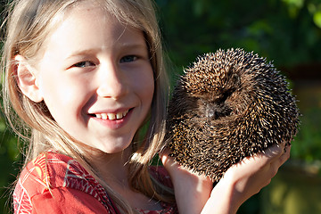 Image showing little girl with cute hedgehog 