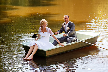 Image showing Young just married bride and groom on boat