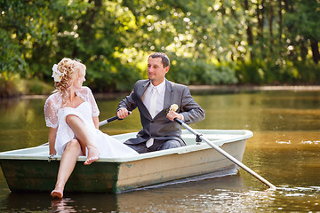 Image showing Young just married bride and groom on boat