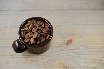 Image showing brown cup with coffee beans 