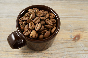 Image showing brown cup with coffee beans