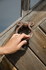 Image showing guest hand knock retro door handle buzzer ringer 