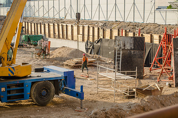 Image showing construction site workers machinery scaffolding 