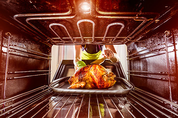 Image showing Cooking chicken in the oven at home.