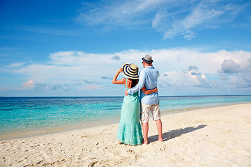 Image showing Vacation Couple walking on tropical beach Maldives.