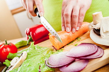 Image showing Woman's hands cutting vegetables