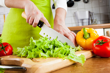 Image showing Woman's hands cutting vegetables