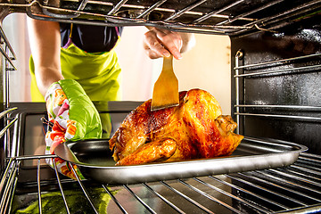 Image showing Cooking chicken in the oven at home.