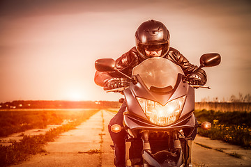 Image showing Biker racing on the road