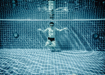 Image showing Persons lies under water in a swimming pool