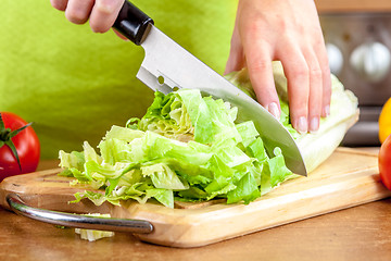 Image showing Woman's hands cutting vegetables