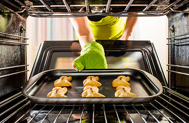 Image showing Baking Gingerbread man in the oven