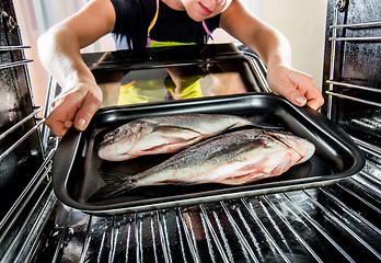 Image showing Cooking Dorado fish in the oven.