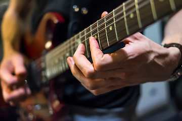 Image showing musician plays a guitar