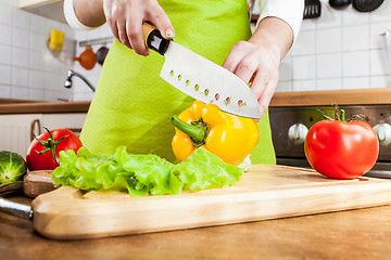 Image showing Woman's hands cutting vegetables