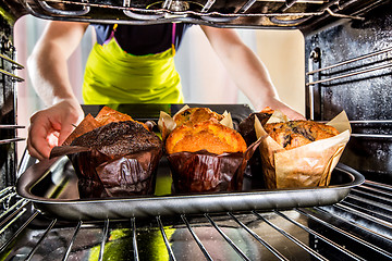 Image showing Baking muffins in the oven