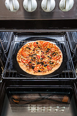 Image showing Pepperoni pizza in the oven.