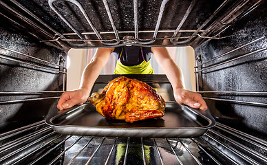 Image showing Cooking chicken in the oven at home.