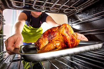 Image showing Cooking chicken in the oven at home.