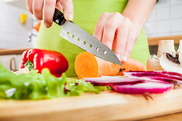 Image showing Woman's hands cutting vegetables