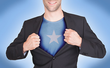 Image showing Businessman opening suit to reveal shirt with flag