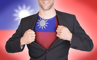 Image showing Businessman opening suit to reveal shirt with flag